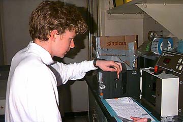 Aaron Putnam, a student from Barrow High School, uses the fluorometer to measure chlorophyll content of melted ice samples.