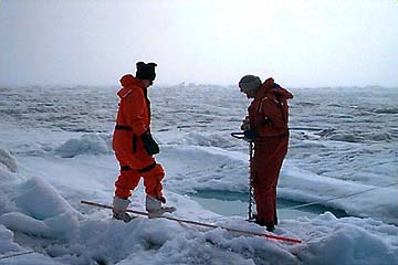 Bill and Aaron drilling holes for stakes which assisted the ROV in filming the under surface of the ice.
